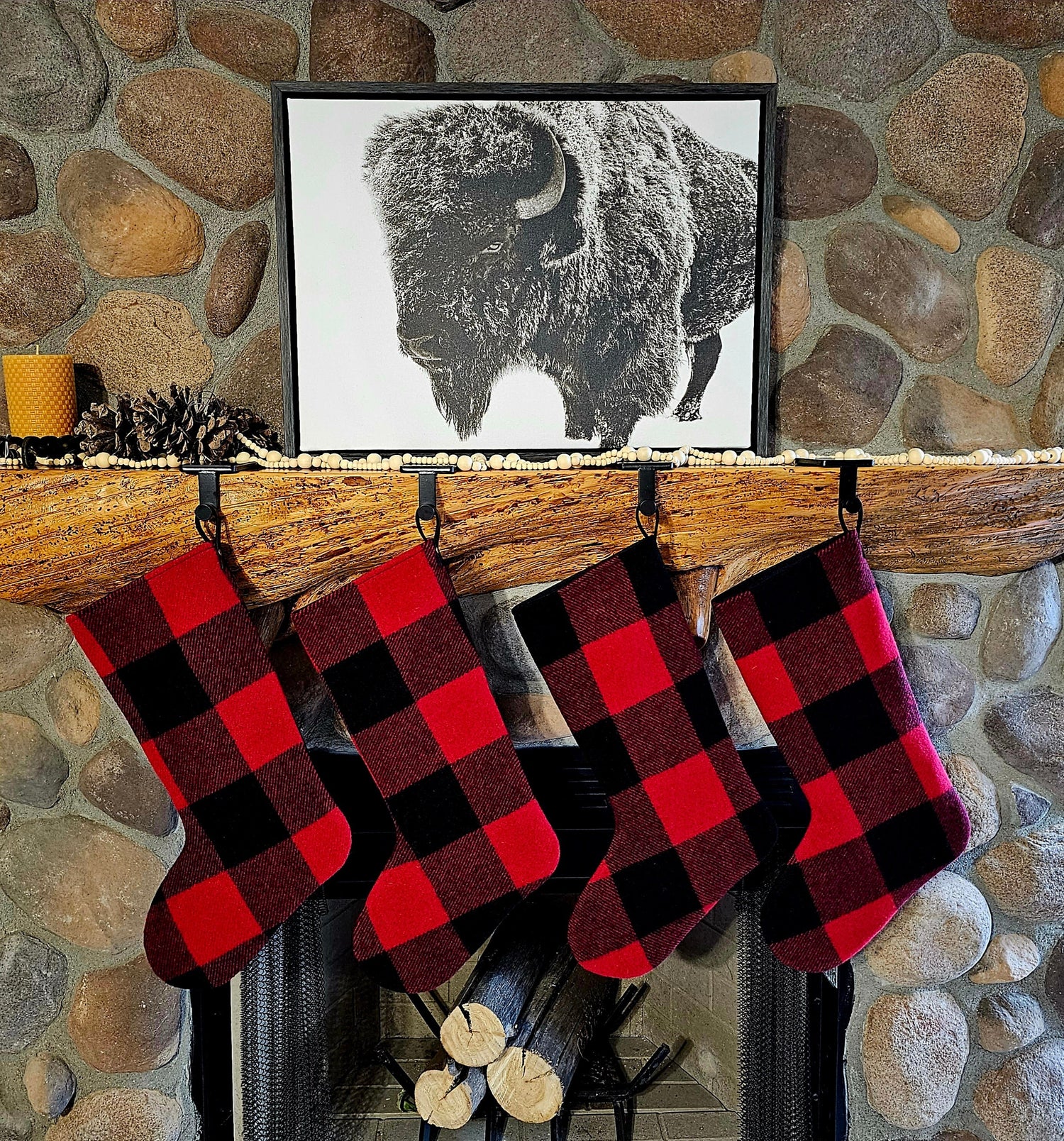 Christmas stockings featuring Pendleton® Rob Roy eco-wise fabric hanging on a mantle. Red and black buffalo check Christmas socks.