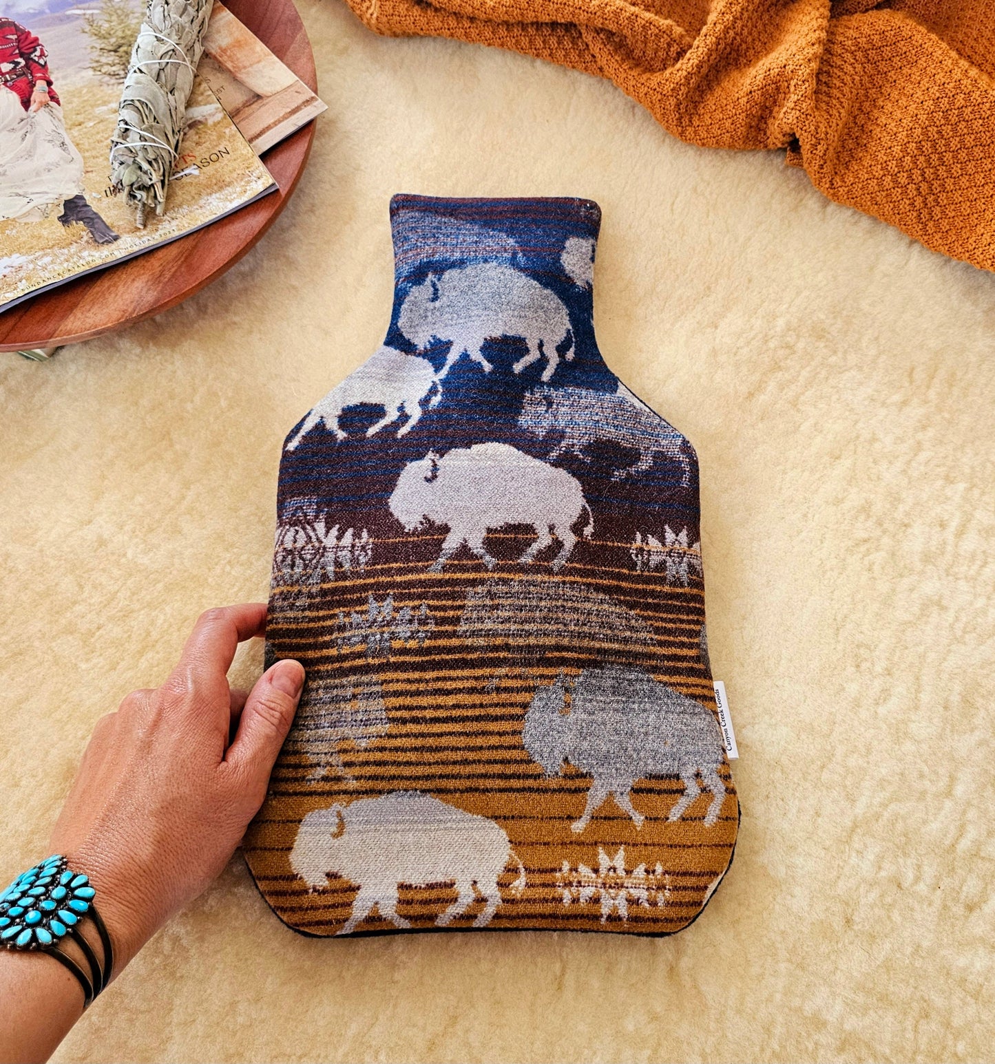 Land of the buffalo print wool hot water bottle cover, featuring navy, brown & camel background with grey buffalo and star designs.