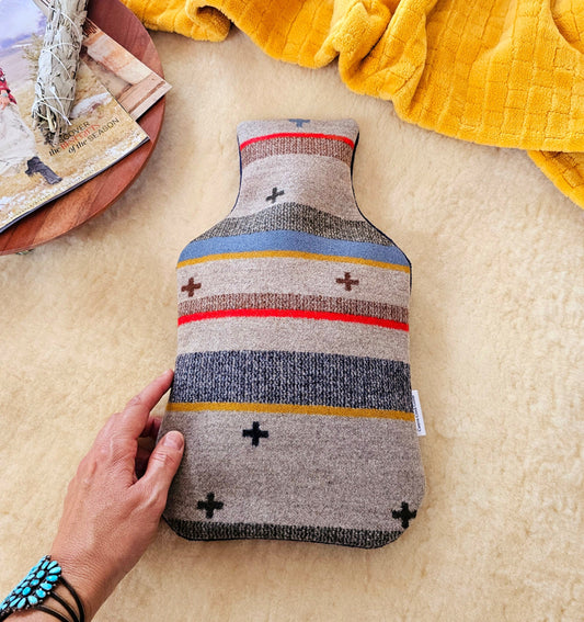 Wool hot water bottle cover, featuring heather background with colorful stripes and swiss cross symbols. Handmade with Pendleton wool in Scout Stripe design.